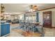 Open-concept dining room features a wooden table with seating for eight and a view of the living room at 3526 Harmony Hwy, Harmony, NC 28634