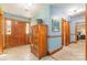 Welcoming foyer featuring a wooden storage cabinet, tiled floors, and detailed trim around the doorframes at 3526 Harmony Hwy, Harmony, NC 28634