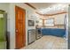 The kitchen features white and blue cabinets, stainless steel appliances, and a large window at 3526 Harmony Hwy, Harmony, NC 28634