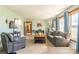 Cozy living room featuring comfortable seating, a wooden coffee table, and natural light filtering through the windows at 3526 Harmony Hwy, Harmony, NC 28634