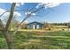 Blue barn with open bay and horse pasture beyond at 3526 Harmony Hwy, Harmony, NC 28634