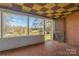 Relaxing sunroom with natural light offering scenic outdoor views, perfect for enjoying nature indoors at 3526 Harmony Hwy, Harmony, NC 28634