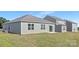 The backyard has a large lawn, grey siding, and a concrete patio at 3543 Cramer Creek Dr, Gastonia, NC 28056