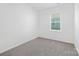 Minimalist bedroom with neutral carpet and one window provides an empty, clean space at 3543 Cramer Creek Dr, Gastonia, NC 28056
