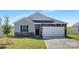 Charming single-story home with stone accents, gray siding, and a well-manicured front lawn at 3543 Cramer Creek Dr, Gastonia, NC 28056