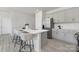 Modern kitchen island with seating, a sink, and stainless steel appliances in an open layout at 3543 Cramer Creek Dr, Gastonia, NC 28056