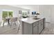 Open-concept kitchen with stainless steel appliances, an island, and a view of the dining area at 3543 Cramer Creek Dr, Gastonia, NC 28056