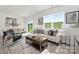 Cozy living room with natural light, a comfortable sofa, and views of the adjacent dining area at 3543 Cramer Creek Dr, Gastonia, NC 28056