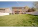 Expansive backyard with a brick home exterior, featuring a pergola with seating, a grill, and a hot tub at 3613 Martele Dr, Mint Hill, NC 28227