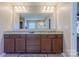 Neutral bathroom featuring a granite countertop and expansive vanity mirror at 3613 Martele Dr, Mint Hill, NC 28227