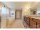 Bright bathroom with large soaking tub, glass enclosed shower and dual sink vanity at 3613 Martele Dr, Mint Hill, NC 28227