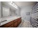 Bathroom featuring white vanity, neutral walls, shower with curtains, and vinyl floors at 3613 Martele Dr, Mint Hill, NC 28227