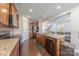 Modern kitchen featuring granite countertops, stainless steel appliances and wood cabinets at 3613 Martele Dr, Mint Hill, NC 28227