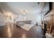 Open-concept living room with hardwood flooring, fireplace, and staircase at 3613 Martele Dr, Mint Hill, NC 28227