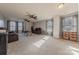 A spacious living room with plush seating, a ceiling fan, large windows, and carpet flooring at 3613 Martele Dr, Mint Hill, NC 28227