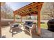 Outdoor patio featuring a shaded pergola with seating and a built-in grill at 3613 Martele Dr, Mint Hill, NC 28227