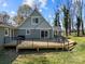 Large, new wooden back deck with black metal railing on a home with green siding and mature landscaping at 3647 Glen Haven Sw Dr, Concord, NC 28027