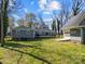 Expansive backyard showcasing a well-maintained lawn and a detached garage at 3647 Glen Haven Sw Dr, Concord, NC 28027
