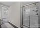 Bathroom featuring a shower with glass doors, neutral walls and dark floors at 3647 Glen Haven Sw Dr, Concord, NC 28027