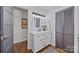 Bathroom featuring vanity with drawers, large mirror, and a gray sliding door at 3647 Glen Haven Sw Dr, Concord, NC 28027