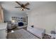 Charming bedroom featuring a ceiling fan, area rug and well-stocked book collection at 3647 Glen Haven Sw Dr, Concord, NC 28027