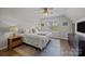 Well-lit bedroom with ceiling fan, large window and stylish area rug at 3647 Glen Haven Sw Dr, Concord, NC 28027