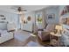 Bedroom with sitting area, hardwood floors, ceiling fan and two windows at 3647 Glen Haven Sw Dr, Concord, NC 28027