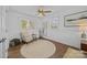Comfortable bedroom showcasing a round rug, a chair, a mirror and natural light from the windows at 3647 Glen Haven Sw Dr, Concord, NC 28027