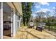 Outdoor deck with wood floors, metal railing, and outdoor seating with wooded area views at 3647 Glen Haven Sw Dr, Concord, NC 28027