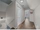 Hallway with access to the bathroom and exercise room, and leading downstairs to the other floors at 3647 Glen Haven Sw Dr, Concord, NC 28027