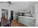 Open-concept kitchen featuring gray cabinets, stainless appliances, quartz counters, and breakfast bar at 3647 Glen Haven Sw Dr, Concord, NC 28027
