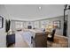 Well-lit living room featuring neutral paint, hardwood floors, a fireplace, and cozy furnishings at 3647 Glen Haven Sw Dr, Concord, NC 28027