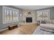 Bright living room showcases a cozy fireplace, hardwood floors, and neutral paint throughout at 3647 Glen Haven Sw Dr, Concord, NC 28027