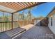 Spacious, updated wood deck with pergola, stained wood railings, and storage shed at 3753 Capps Hill Dr, Charlotte, NC 28216