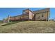 A backyard with a wooden deck elevated on a grass hill at 3753 Capps Hill Dr, Charlotte, NC 28216