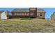 A backyard with a wooden deck elevated on a grass hill at 3753 Capps Hill Dr, Charlotte, NC 28216