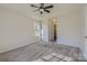 A carpeted bedroom featuring a tray ceiling, ceiling fan, and ample natural light from the window at 3753 Capps Hill Dr, Charlotte, NC 28216