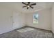 Bedroom with neutral walls, carpet flooring, a sunlit window, and a ceiling fan at 3753 Capps Hill Dr, Charlotte, NC 28216