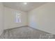 A cozy bedroom features neutral walls, carpet flooring, and a sunlit window at 3753 Capps Hill Dr, Charlotte, NC 28216