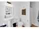 Clean and bright bathroom with a pedestal sink, toilet, and shower at 411 Walnut St, Davidson, NC 28036