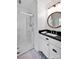 Bright bathroom with a glass-enclosed shower and elegant black vanity at 411 Walnut St, Davidson, NC 28036
