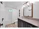 Well-lit bathroom features a tub, marble vanity, and decorative tile flooring at 411 Walnut St, Davidson, NC 28036