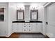 Well-lit bathroom featuring a double vanity with granite countertop, and decorative mirrors at 411 Walnut St, Davidson, NC 28036