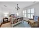 Charming bedroom with a four-poster bed, quilt bedding, and natural light from the shuttered windows at 411 Walnut St, Davidson, NC 28036