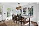 Sunlit dining room with a large table, bench seating, and multiple windows at 411 Walnut St, Davidson, NC 28036