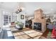 Sunny dining area with an adjacent fireplace and an open view into the kitchen at 411 Walnut St, Davidson, NC 28036