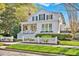 Lovely two-story home with a welcoming front porch and a beautifully maintained lawn at 411 Walnut St, Davidson, NC 28036
