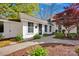 Charming exterior view showcasing the well-manicured landscaping, gravel walkway and architectural details at 411 Walnut St, Davidson, NC 28036
