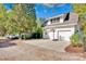 Two-car garage features a basketball hoop on a concrete driveway, with greenery surrounding the property at 411 Walnut St, Davidson, NC 28036