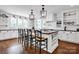 Bright kitchen with large island, pendant lighting, and modern black and white accents at 411 Walnut St, Davidson, NC 28036